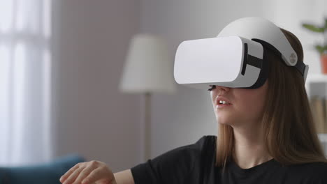 woman-with-head-mounted-display-is-gesticulating-by-hands-swiping-and-tapping-modern-technology-of-virtual-reality-medium-female-portrait-indoor